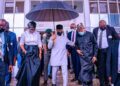 Nigerians react to viral photo of Vice President, Osinbajo holding umbrella to cover himself, two others